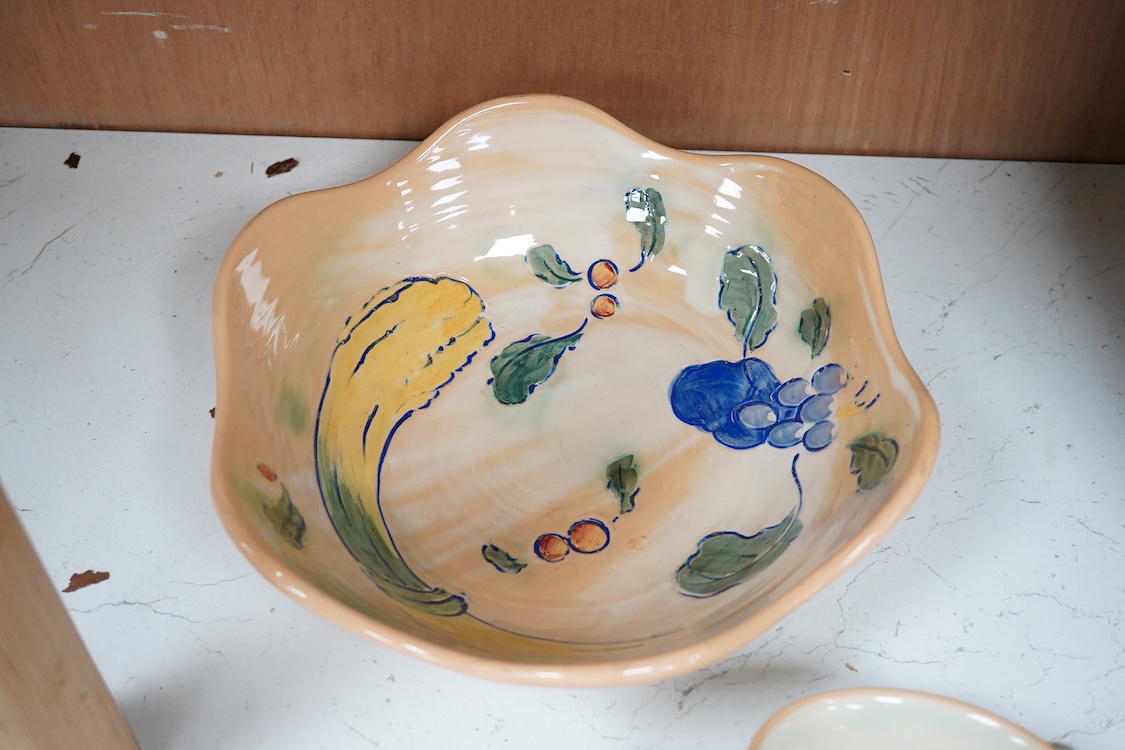 A collection of Doulton Brangwynware to include a bowl, two teacups and seven side plates, largest 34cm in diameter